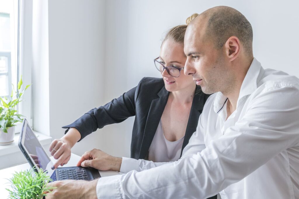 close up male female businesspeople working laptop workplace