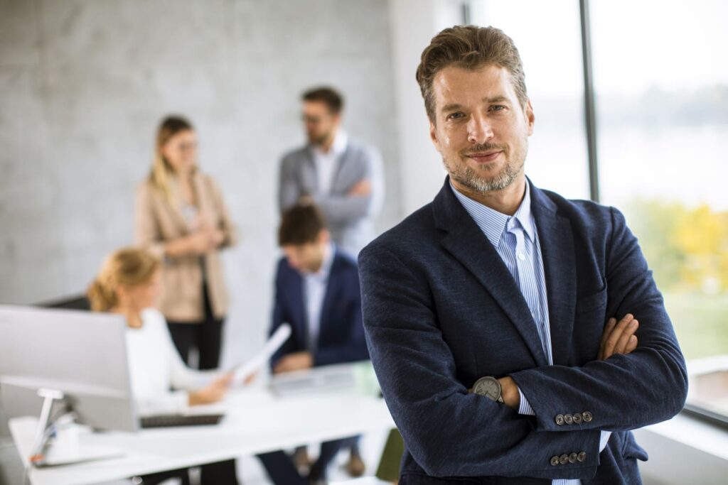handsome young business man standing confident office front his team