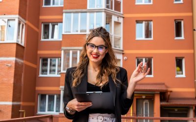 Estate agent with key against new house. Moving home or renting property