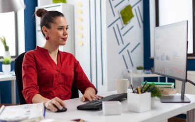 Woman entrepreneur working on financial expertise from company office. looking at charts and graphs of start up. Concentrated employee typing on keyboard checking project status.